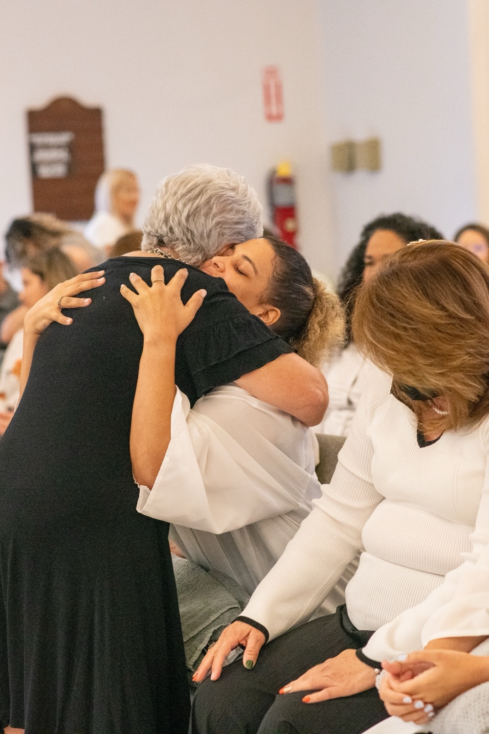 Abrazo durante un servicio de bautismos en la iglesia.